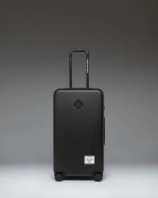 Black Herschel Heritage Hardshell Medium Luggage in black, front view.