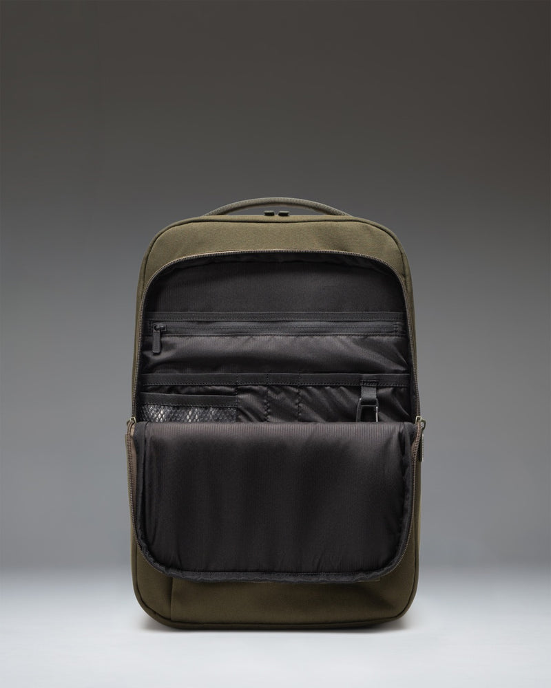 Herschel Supply Co. Kaslo Daypack Tech in Ivy Green Tonal, showing a close-up of the backpack's textured durable fabric and zippered compartments.