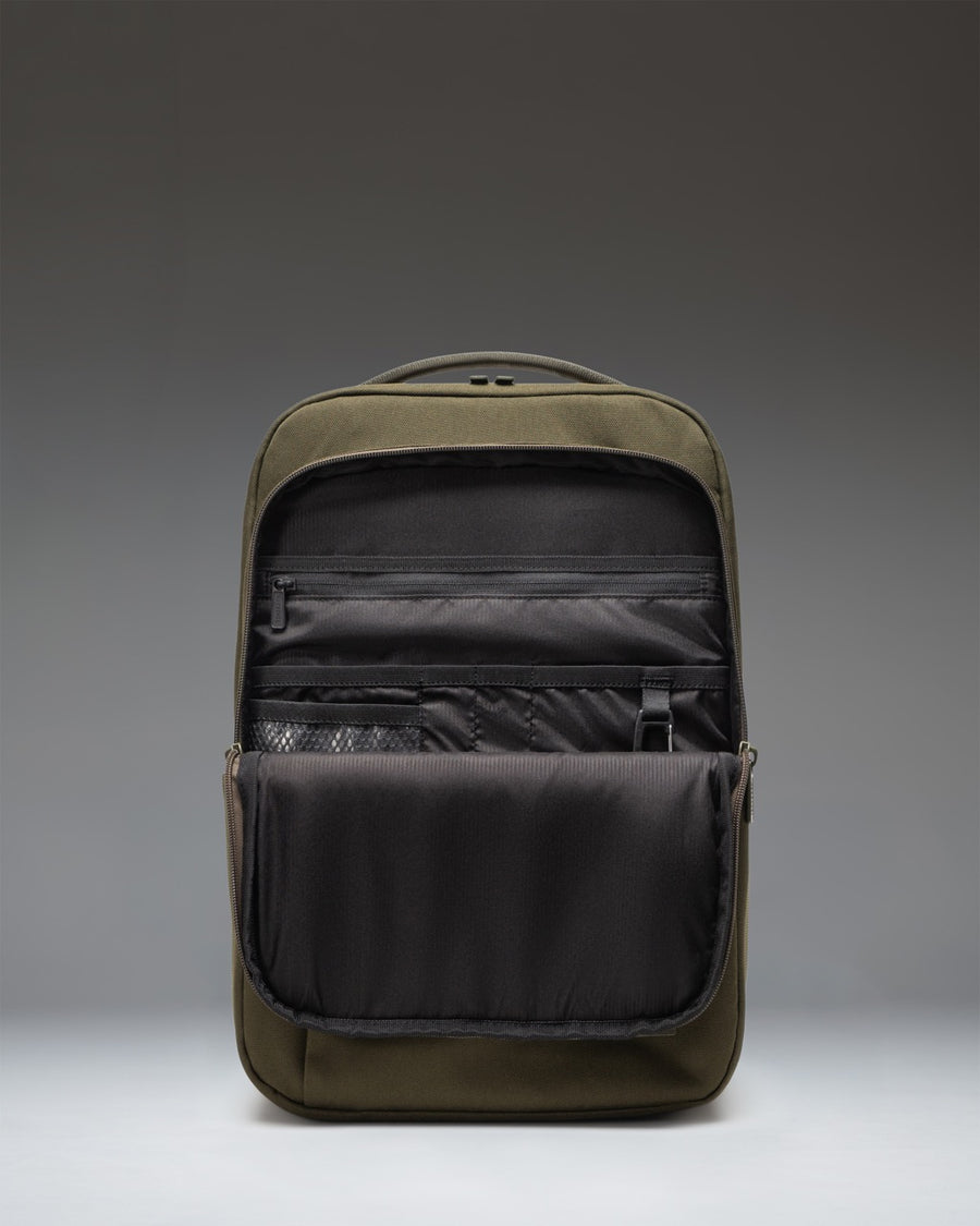 Herschel Supply Co. Kaslo Daypack Tech in Ivy Green Tonal, showing a close-up of the backpack's textured durable fabric and zippered compartments.