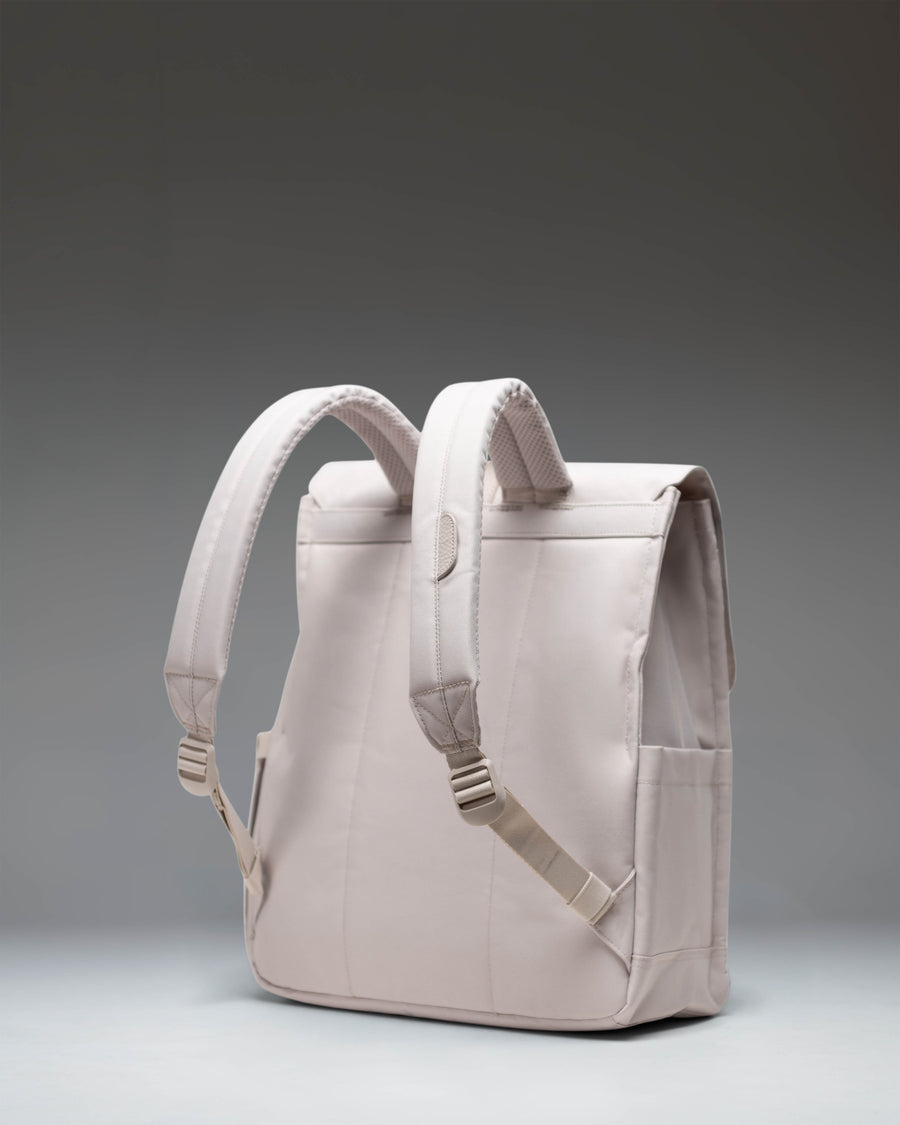 Herschel Supply Co. City Backpack in Moonbeam, a cream-white everyday bag with a single front magnetic strap closure.