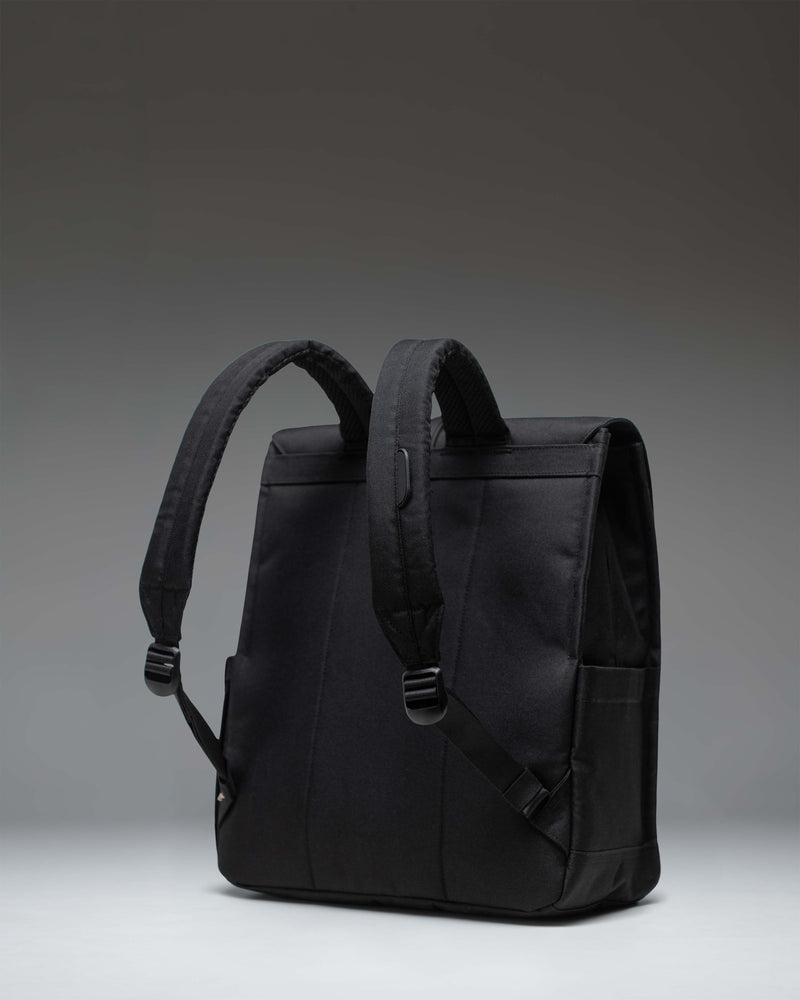 Herschel Supply Co. Black Tonal City Backpack with a sleek minimalist design, featuring a single strap with a metal pin buckle closure.
