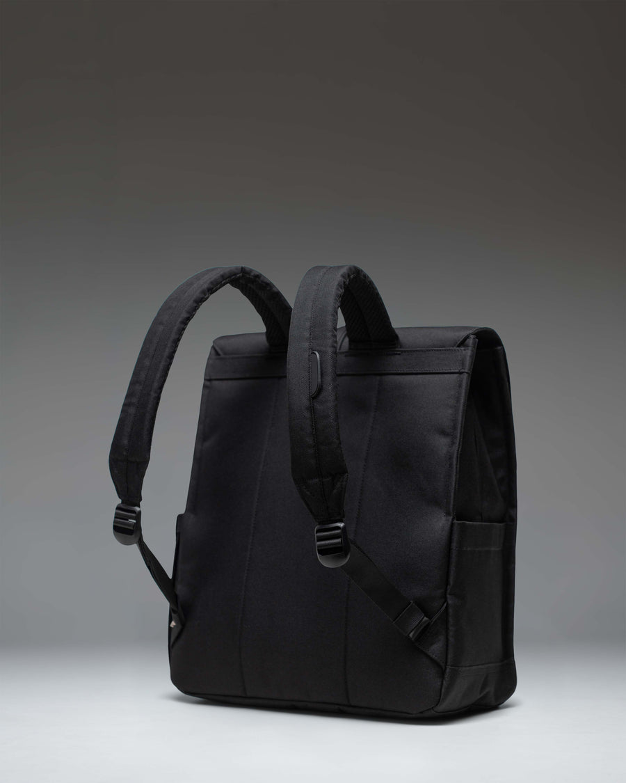 Herschel Supply Co. Black Tonal City Backpack with a sleek minimalist design, featuring a single strap with a metal pin buckle closure.