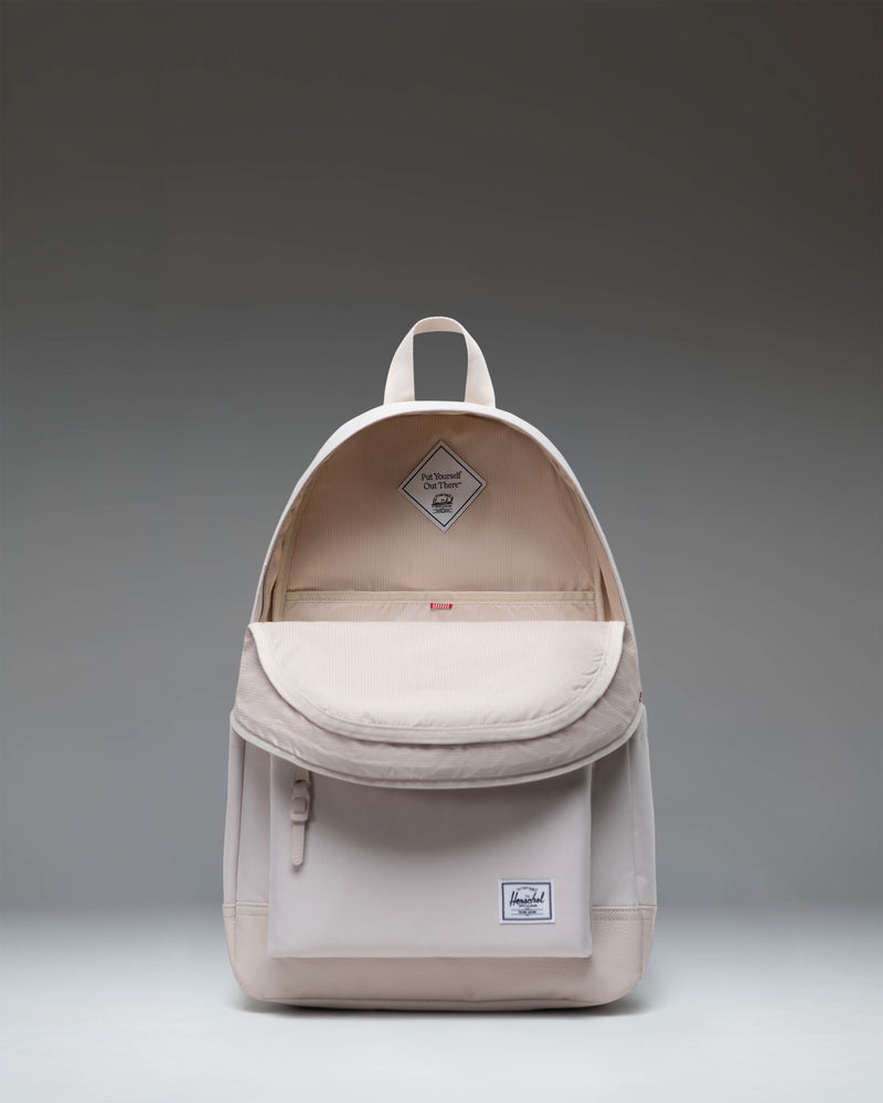 Herschel Heritage Backpack in Moonbeam colorway showing the front view with classic diamond accent and zippered front pocket.