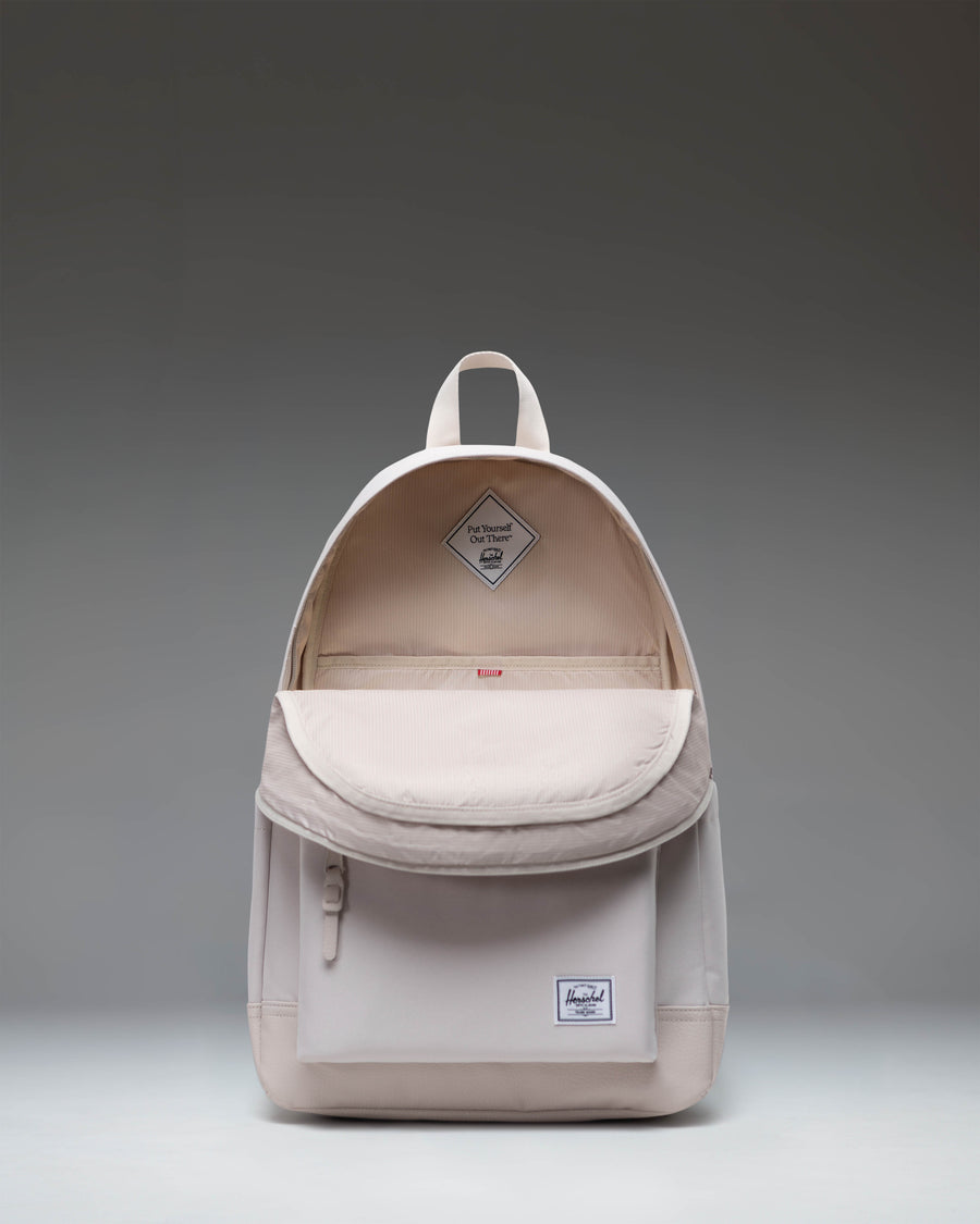 Herschel Heritage Backpack in Moonbeam colorway showing the front view with classic diamond accent and zippered front pocket.