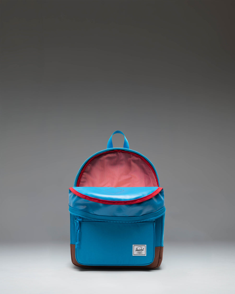 Herschel Supply Co. Heritage Kids backpack in Hawaiian Surf turquoise with a Saddle Brown base, front pocket, and adjustable padded shoulder straps.