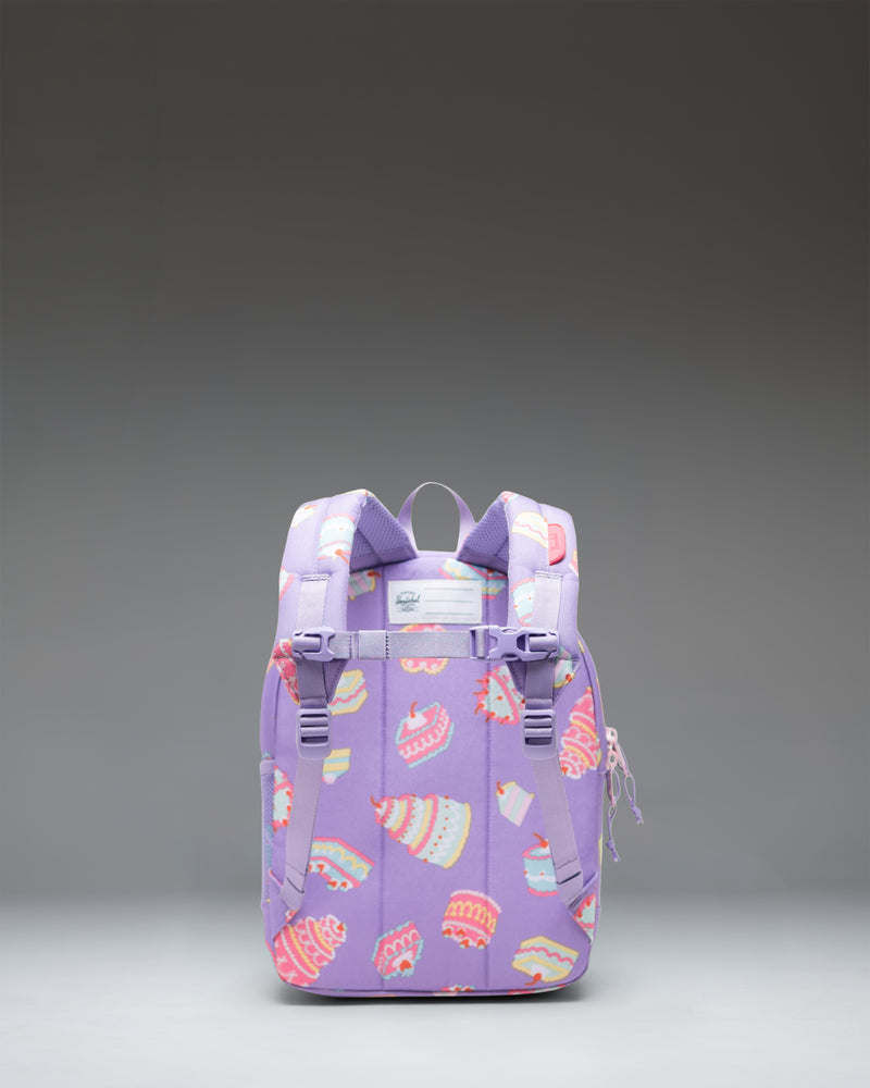 Herschel Heritage Kids Backpack in Cakes, featuring a playful print of birthday cakes with candles on a pastel background.