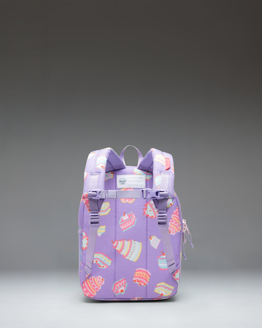 Herschel Heritage Kids Backpack in Cakes, featuring a playful print of birthday cakes with candles on a pastel background.
