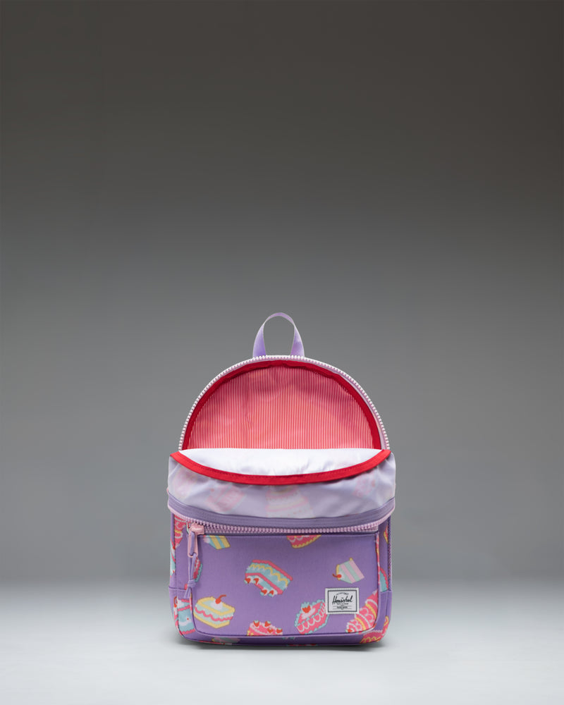 Herschel Heritage Kids Backpack in Cakes colorway, featuring a light blue body patterned with colorful layered cakes and cupcakes.