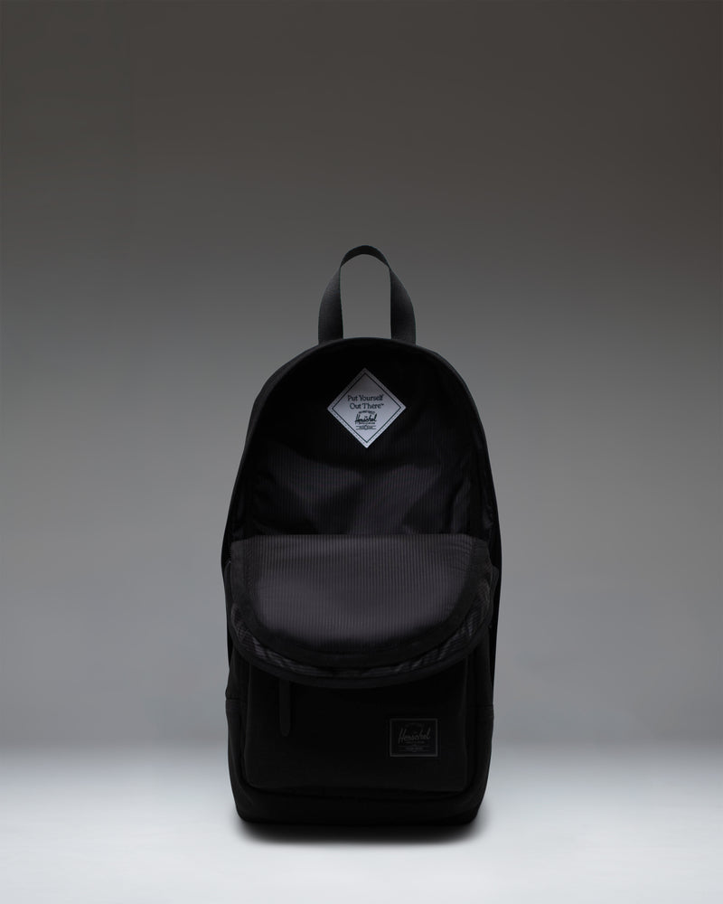 Herschel Heritage Shoulder Bag in Black Tonal, showing a front view of the compact crossbody design.