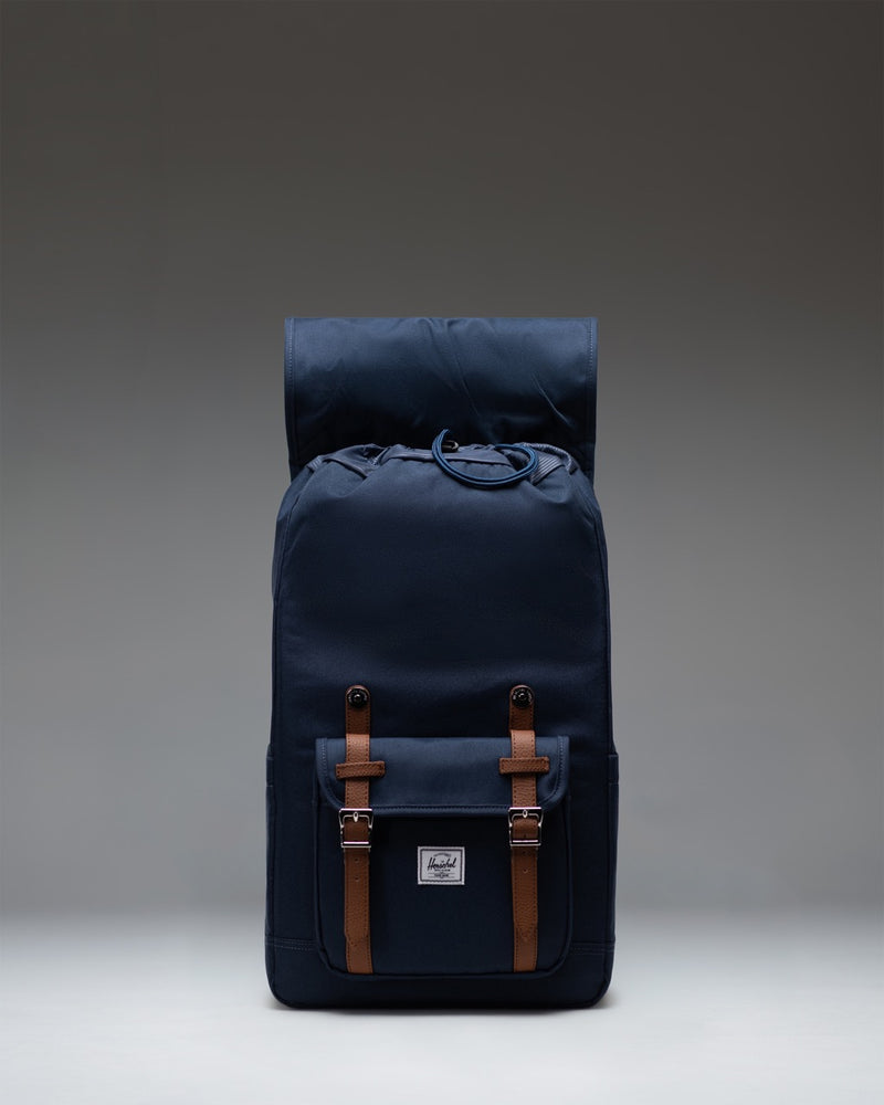 Herschel Supply Co. classic Little America mountaineering backpack in navy blue with signature rubber straps and metal pin buckles.
