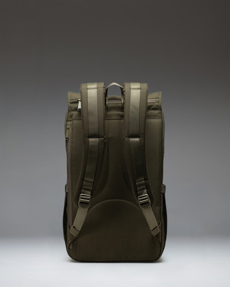 Herschel Little America Backpack in Ivy Green showing a detailed view of the front straps and signature woven label on a clean background.