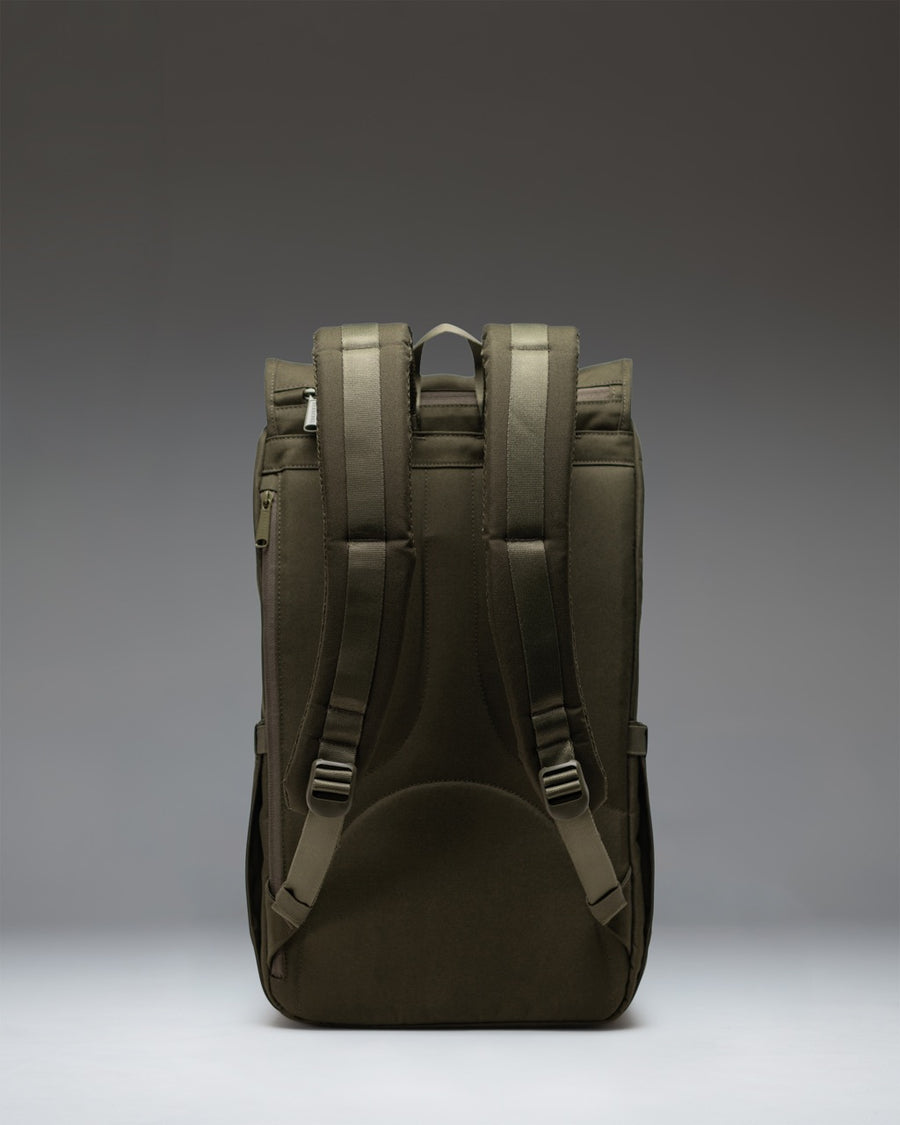 Herschel Little America Backpack in Ivy Green showing a detailed view of the front straps and signature woven label on a clean background.