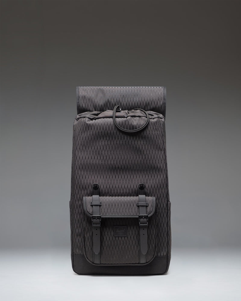 Herschel Little America backpack in Black Diamond/Black featuring a subtle diamond-textured weave and classic mountaineering-style strap closures.