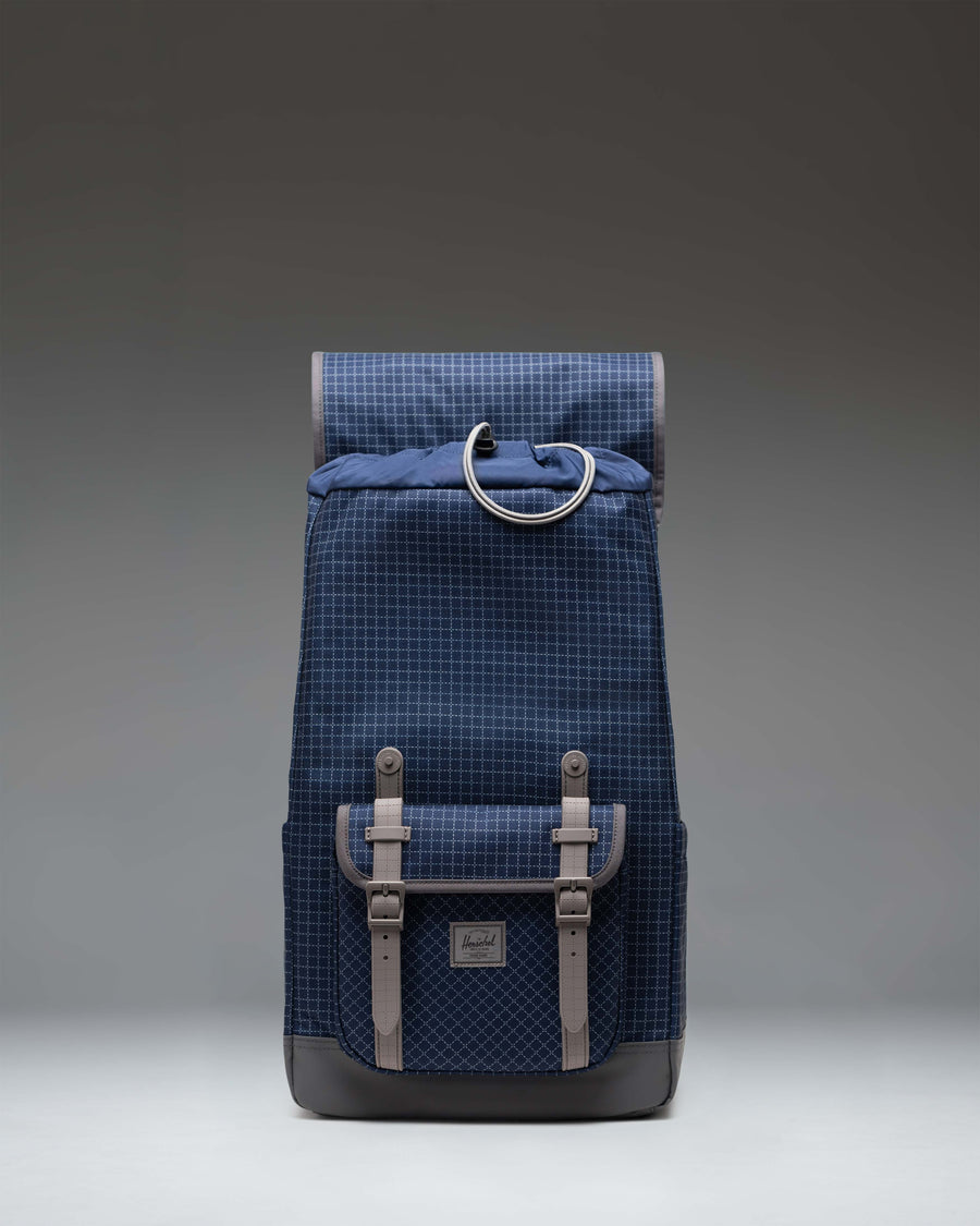 Herschel Little America Backpack in Grid Naval Academy/Magnet, showing the front view with magnetic strap closures and front storage pocket.