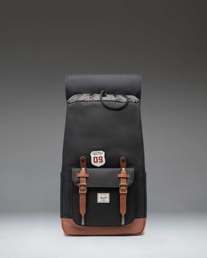Herschel Little America Backpack in Patches Black showing the back panel, padded shoulder straps, and a mesh back for airflow.