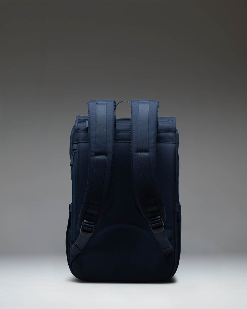Herschel Supply Co. Little America Mid-Volume backpack in classic navy blue featuring adjustable front straps and a compact design.
