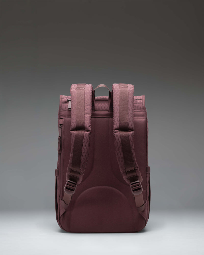 Herschel Little America Mid Backpack in Huckleberry Diamond, featuring a purple diamond-patterned fabric with black rubber strap closures.