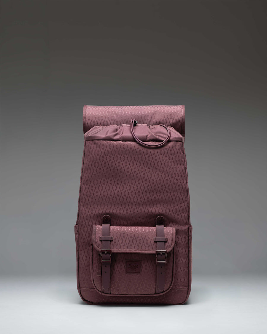 Herschel Little America Mid Backpack in Huckleberry Diamond, featuring a purple geometric pattern, brown rubber straps, and front pocket.