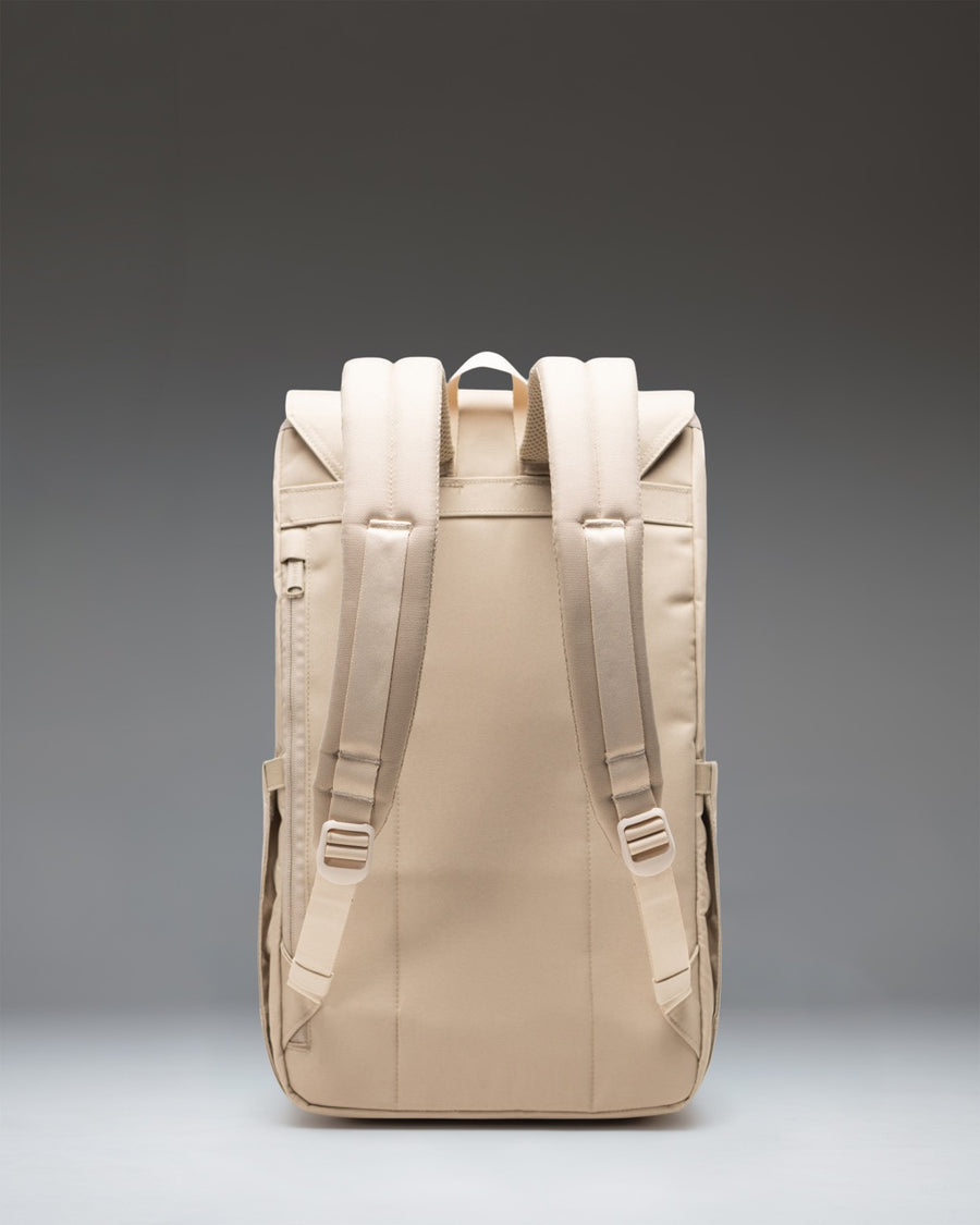 Herschel Supply Co. Retreat Backpack in light green Eucalyptus color featuring a front storage sleeve and magnetic strap closures.