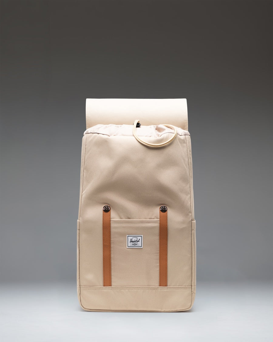 Herschel Supply Co. Retreat Backpack in Eucalyptus green with brown magnetic strap closures and a front storage sleeve.