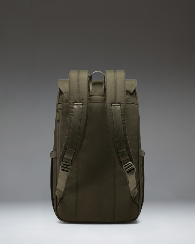 Herschel Retreat Backpack in Ivy Green featuring a classic mountaineering style with dual magnetic strap closures and a woven label.