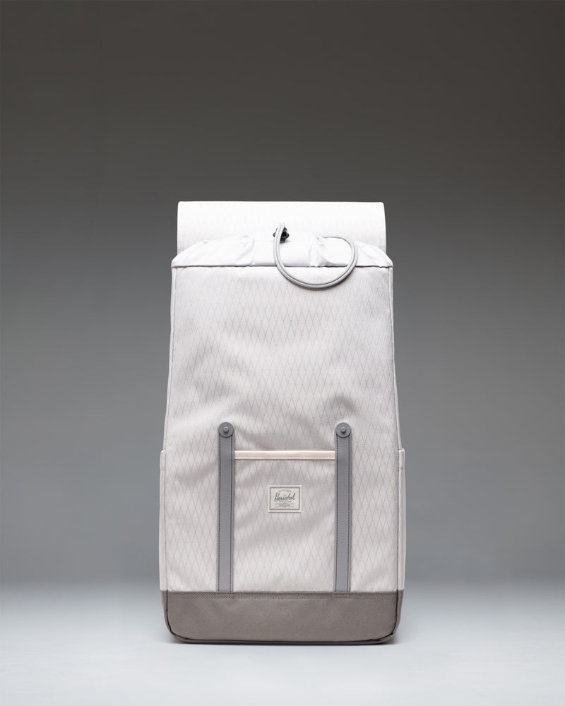 Herschel Retreat Backpack in Vapor Diamond and Charcoal Gray, showcasing its clean design, front straps, and classic woven label.