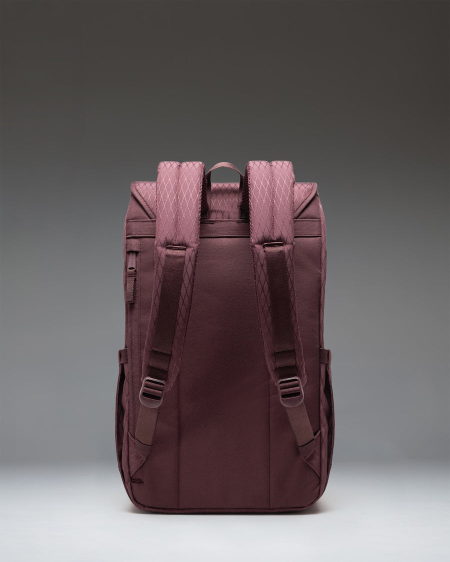 Herschel Retreat Backpack in Huckleberry Diamond featuring a purple geometric pattern, brown rubber straps, and a classic woven label.