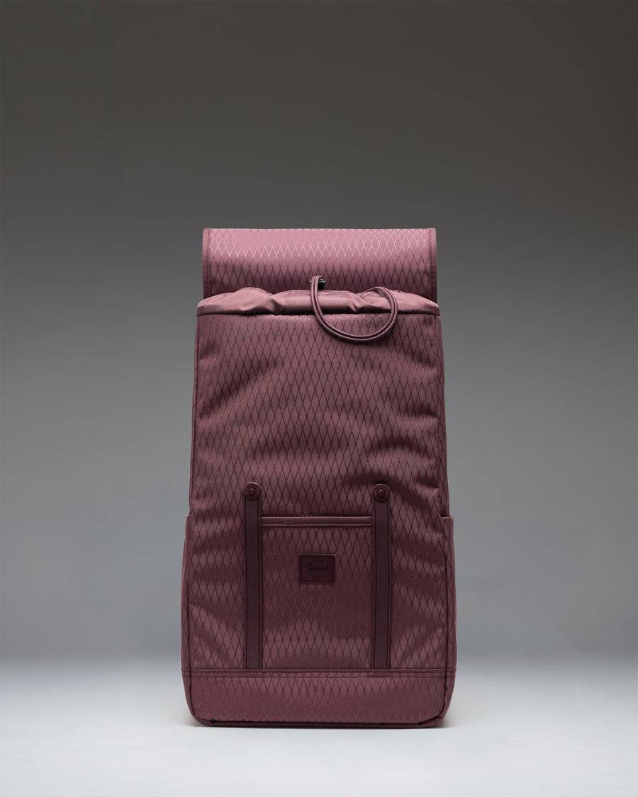 Herschel Retreat Backpack in Huckleberry Diamond, a purple daily laptop backpack featuring a top flap with strap closures.