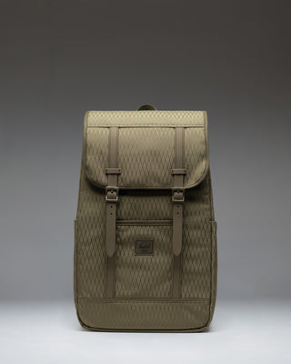 Herschel Supply Co. Retreat Backpack in Ivy Green Diamond with a drawcord closure and magnetic strap detailed top flap.