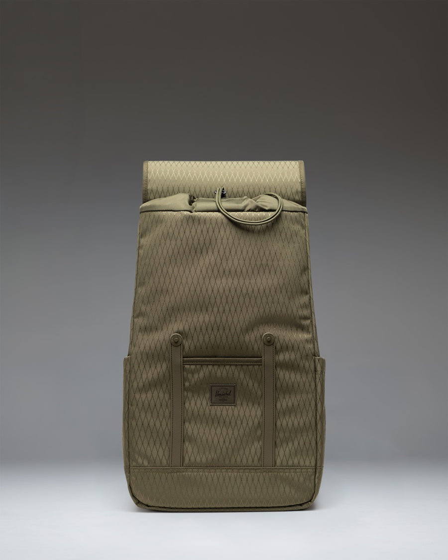 Herschel Retreat Backpack in Ivy Green Diamond, featuring a classic design with front strap closures.