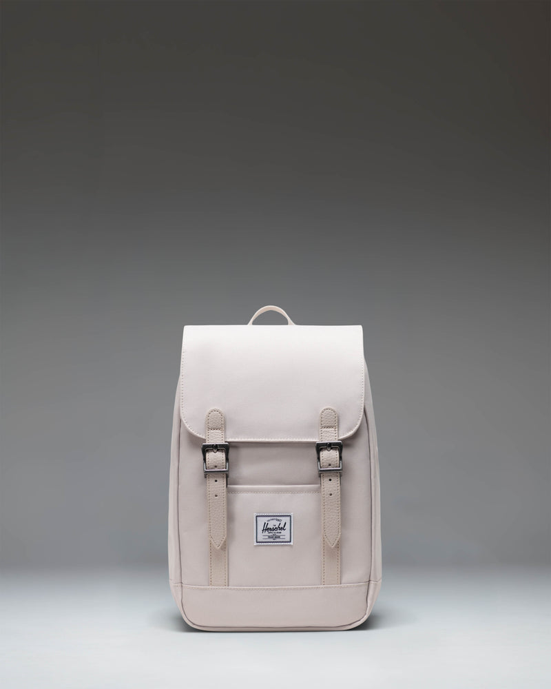 Herschel Retreat Mini Backpack in Moonbeam colorway, featuring a front storage sleeve and magnet fastened straps.