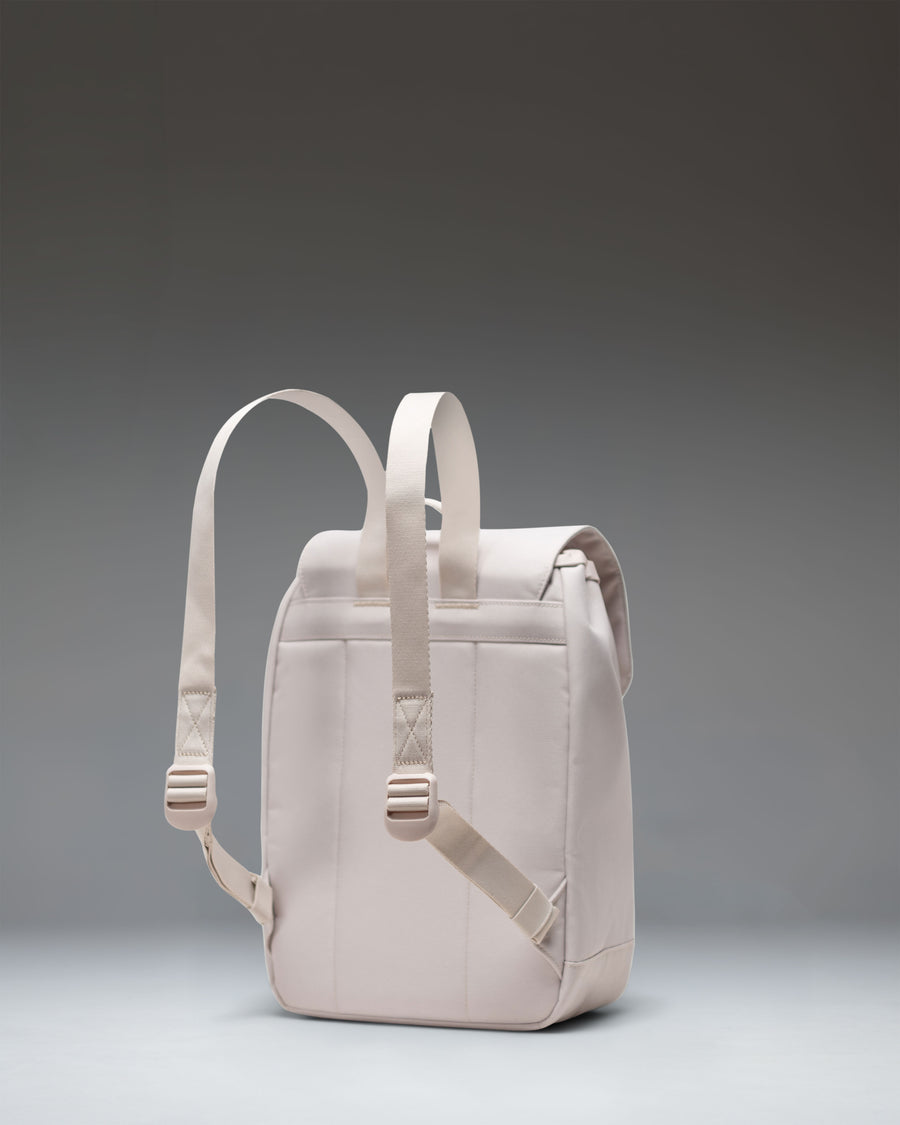 Herschel Retreat Mini Backpack in Moonbeam white, showing a clean front view with a single strap closure and a classic woven label.