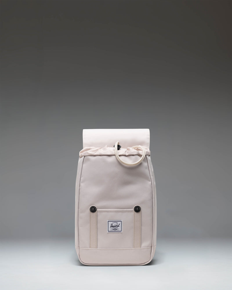 Herschel Retreat Mini Backpack in the light beige Moonbeam colorway, featuring a classic cinch top and front strap closure.