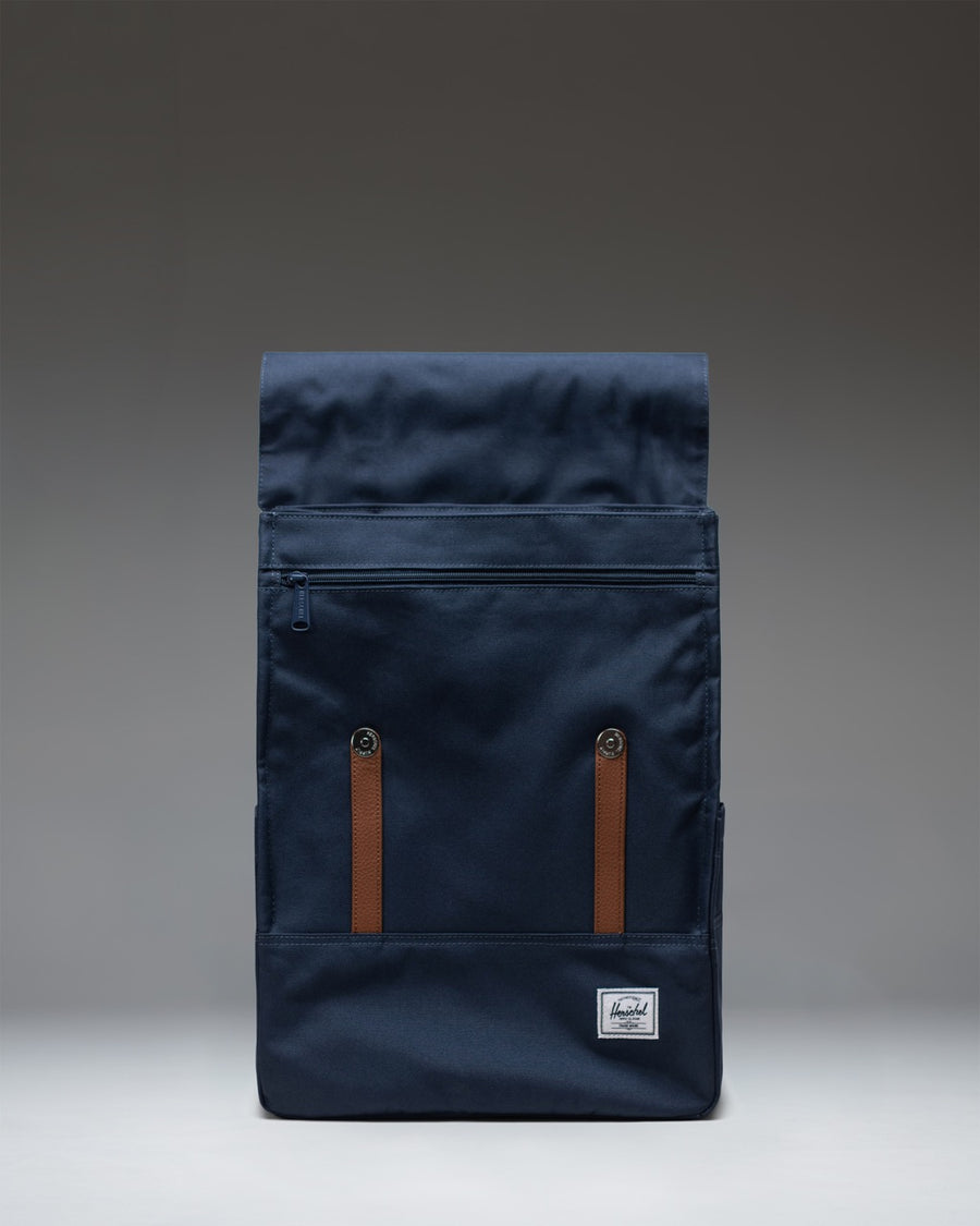 Herschel Survey Backpack in navy blue, shown from the front with its dual magnetic strap closures and clean, classic design.