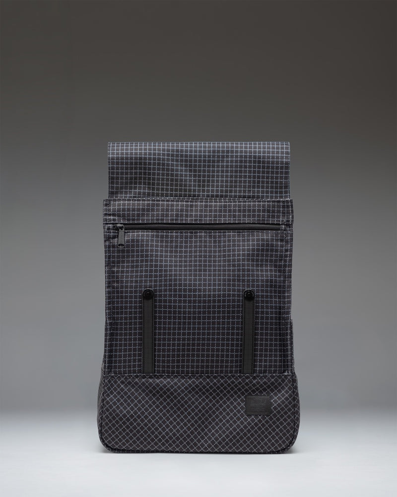 Herschel Survey Backpack in Grid Black featuring a sleek, minimalist design with matte coating and dual strap closures.
