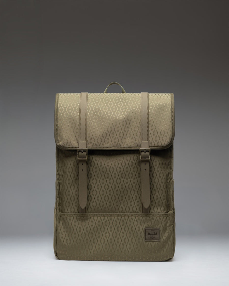 Herschel Survey Backpack in Ivy Green Diamond colorway, featuring a classic rectangular shape and minimalist design with magnetic strap closures.
