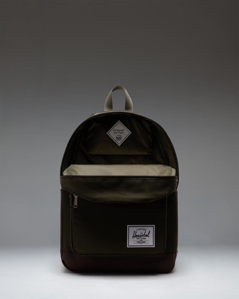 Herschel Supply Co. Pop Quiz Backpack in Ivy Green and Chicory Coffee showing a detailed view of the front zipper pocket and fabric texture.
