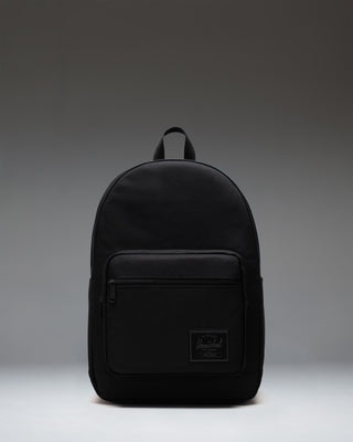 Herschel Supply Co. Pop Quiz Backpack in Black Tonal, showing the front view with a water-resistant zipper and pocket detailing.
