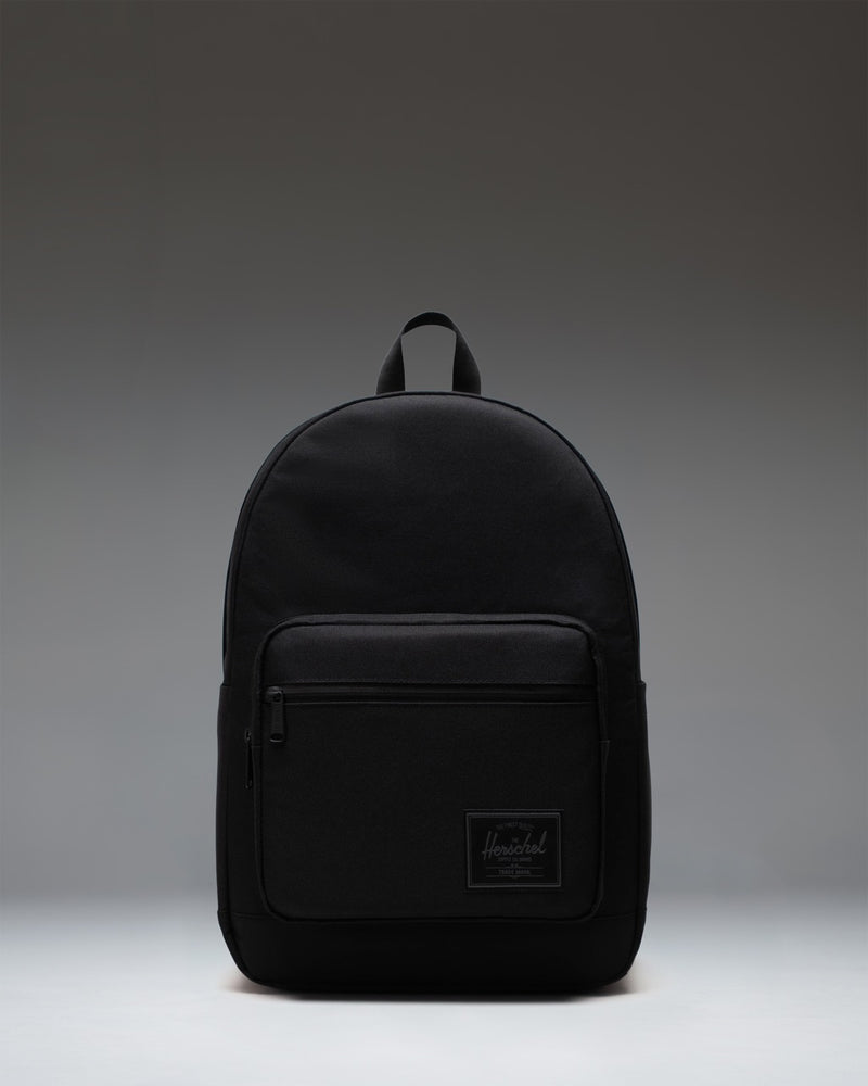 Herschel Supply Co. Pop Quiz Backpack in Black Tonal, showing the front view with a water-resistant zipper and pocket detailing.