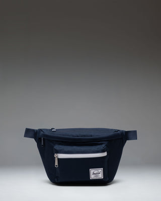 Herschel Supply Co. Pop Quiz Hip Pack in navy blue, showcasing its clean design, front pocket, and adjustable strap.
