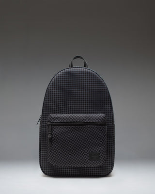 Herschel Supply Co. Settlement Backpack in Grid - Black, shown from the front featuring a modern grid pattern and zippered front pocket.