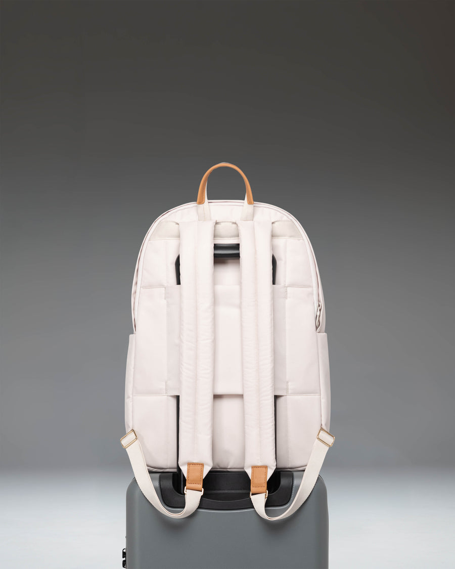 Herschel Supply Co. Beatrix Backpack in Moonbeam colorway showing a sleek design with clean lines, front zippered pocket, and minimalist metal logo.