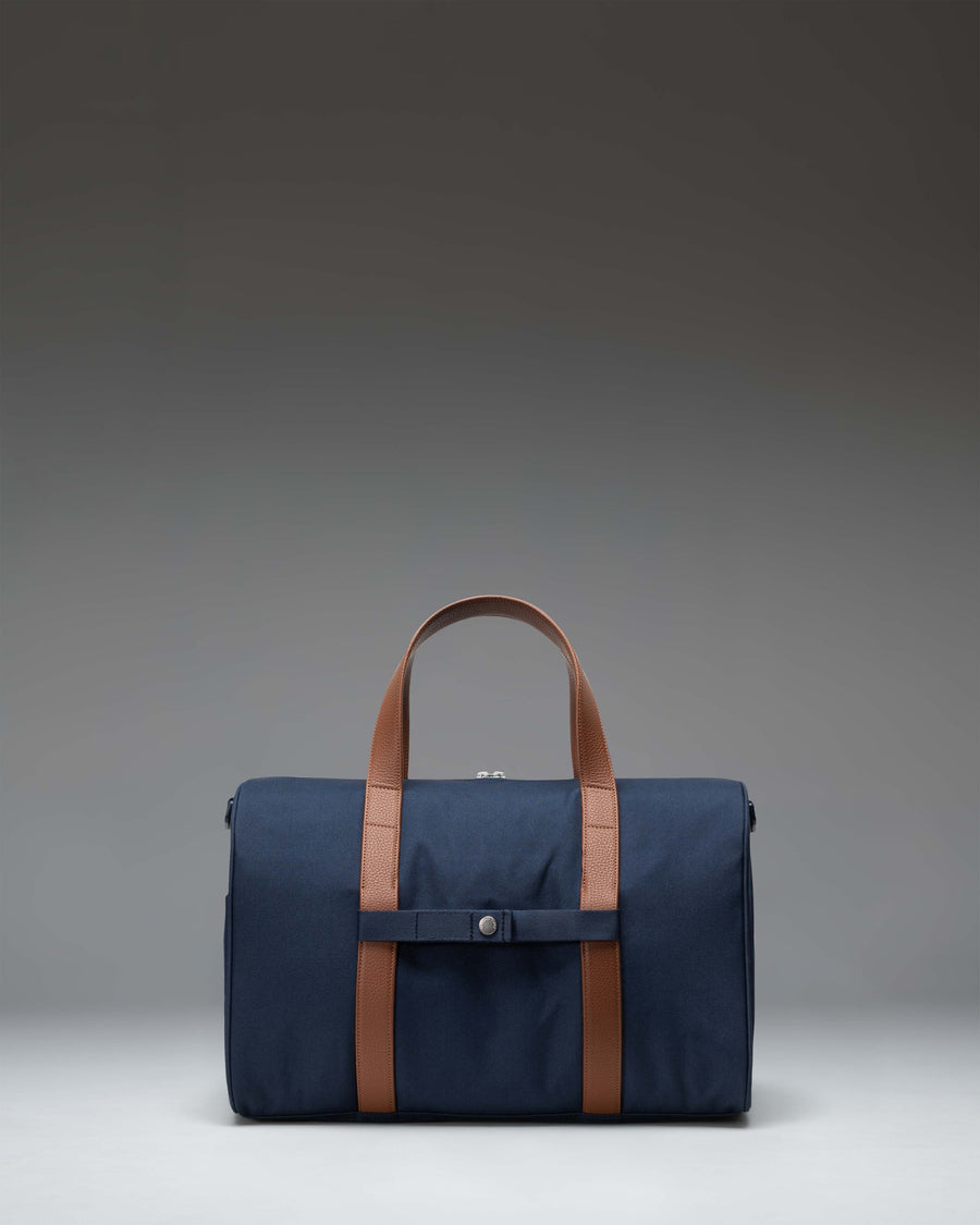 Navy Herschel Novel Carry On Duffle bag featuring a spacious main compartment, signature shoe pocket, and durable top handles.