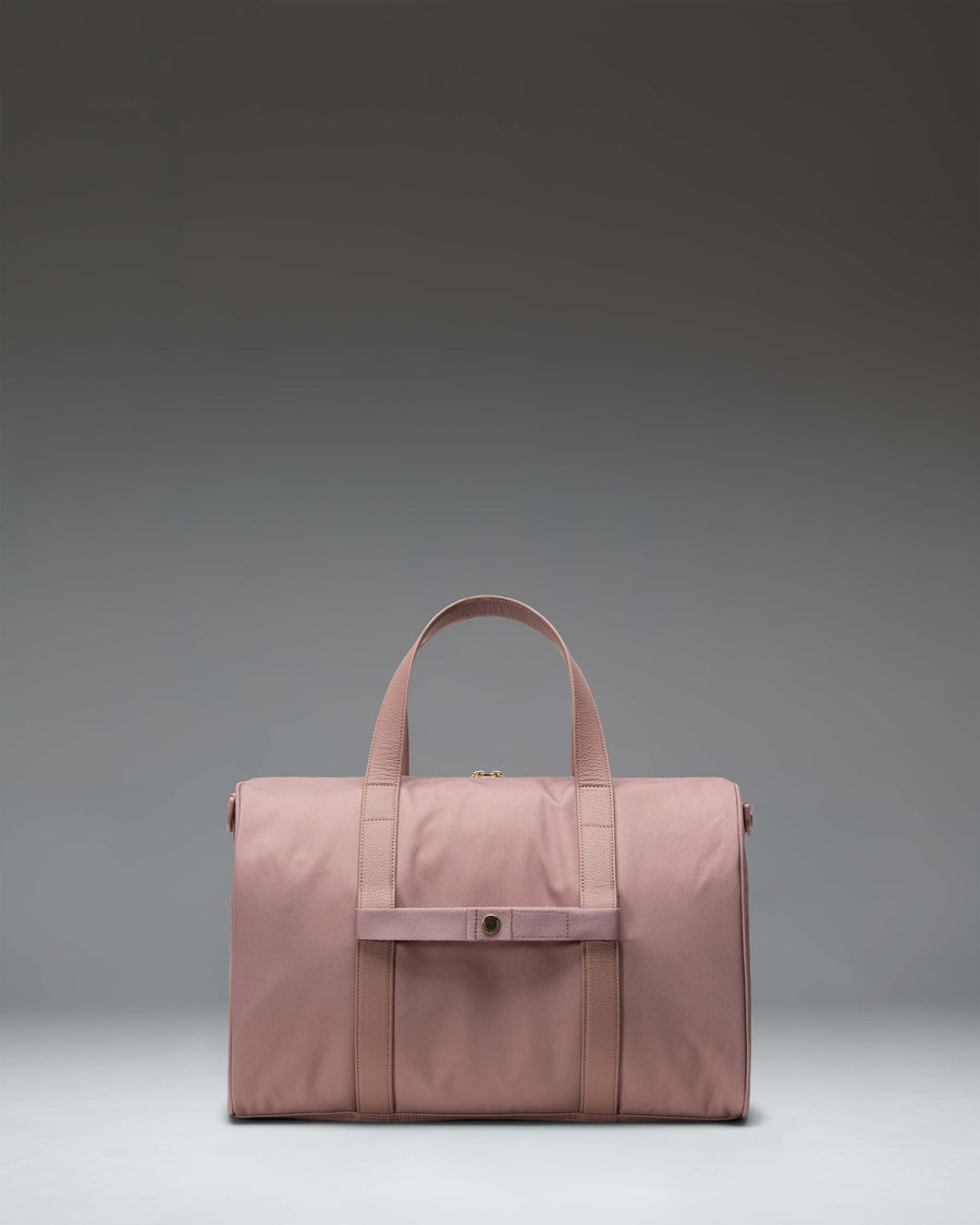 Herschel Novel Carry On Duffle bag in Ash Rose, featuring a clean side profile with tonal handles and a signature shoe compartment.