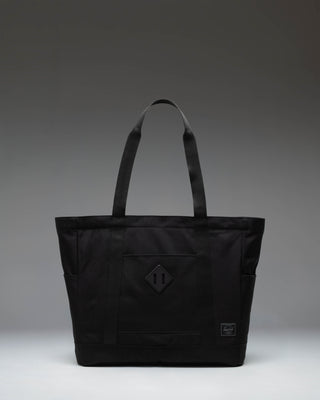 Herschel Heritage Tote in Black Tonal, featuring a clean front view with dual top carrying handles and the classic Herschel logo label.