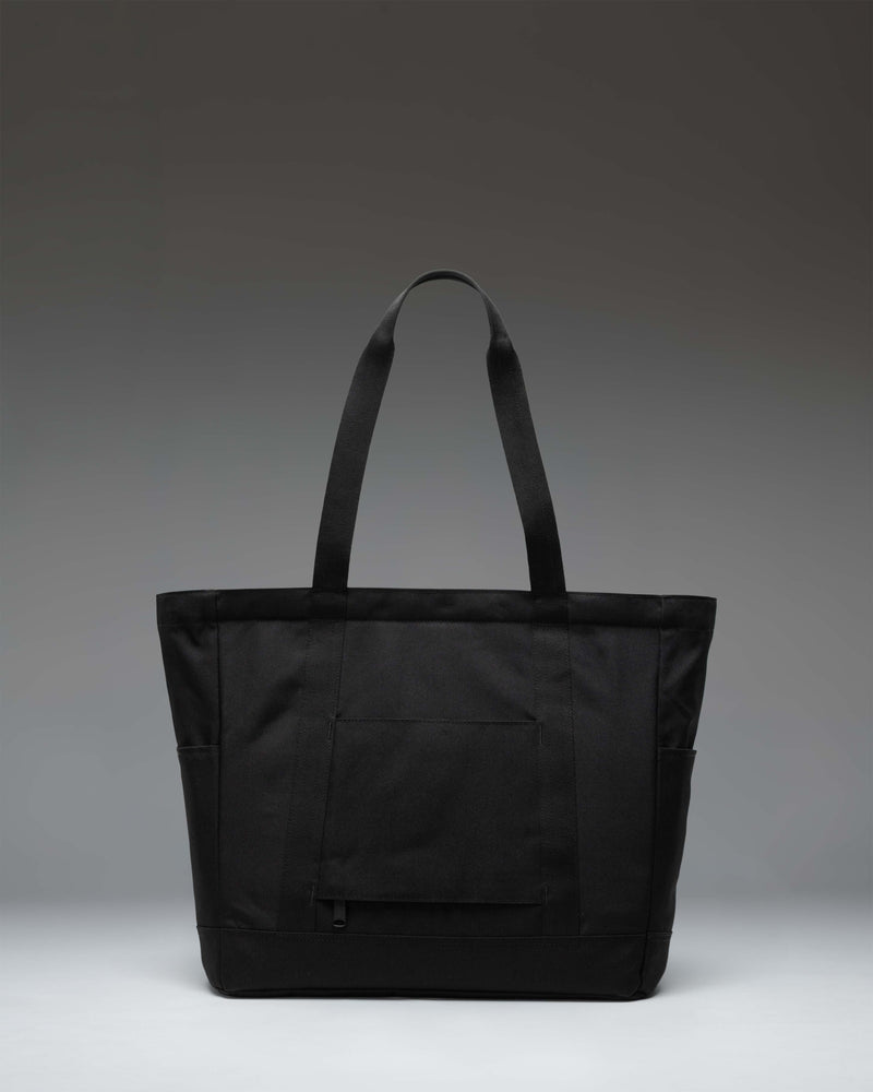 Herschel Heritage Tote bag in Black Tonal featuring classic design with dual top handles and a front zippered storage pocket.