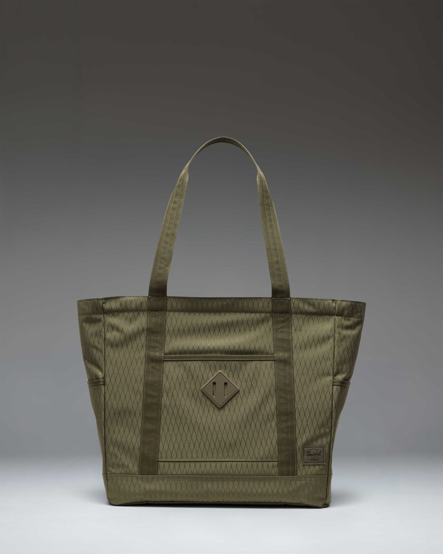 Herschel Heritage Tote in Ivy Green Diamond, featuring a classic design with dual top handles and a signature woven label on the front.