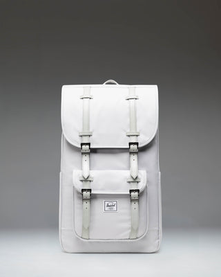 Herschel Little America Backpack in Metal grey, featuring a front pocket with strap details, a top flap closure, and padded shoulder straps.
