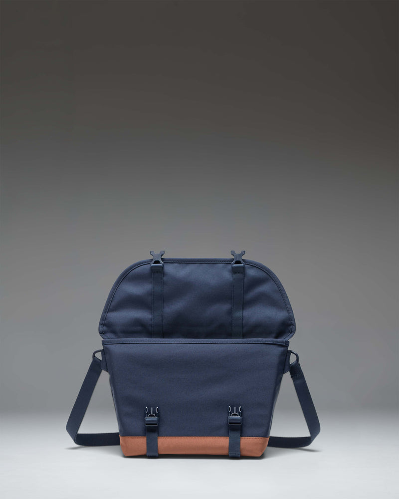 Herschel Supply Co. Cove Small Messenger bag in Navy and Saddle Brown, showing the front view with buckle closures.