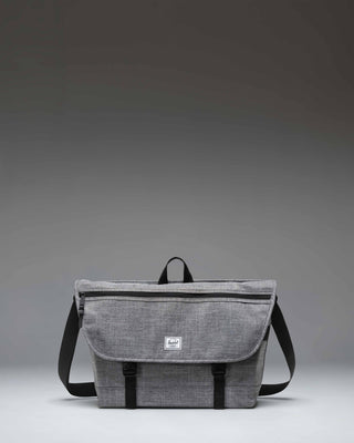 Herschel Supply Co. Cove Messenger bag in Raven Crosshatch grey, showing the front flap, buckle closure, and shoulder strap.